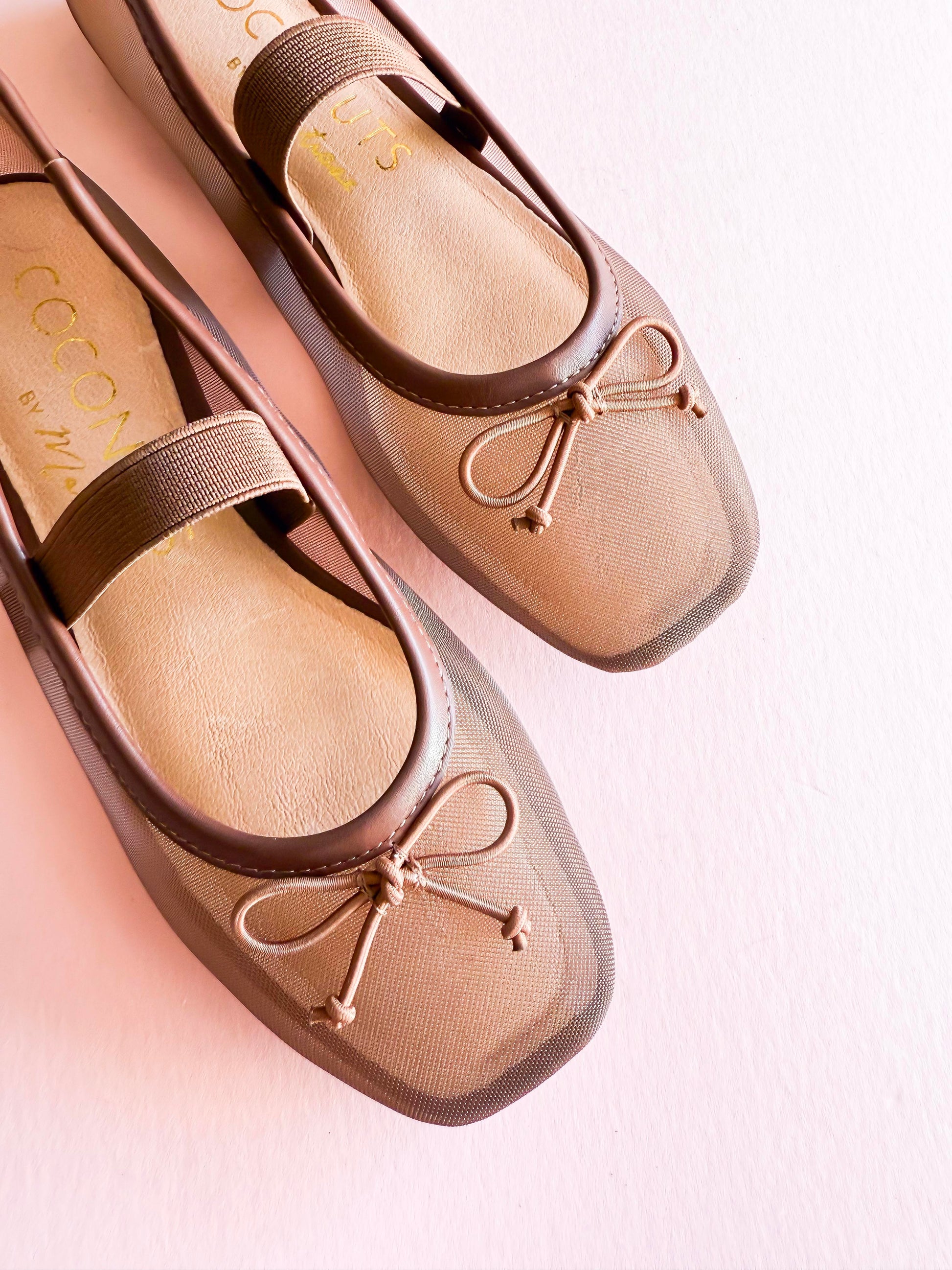 Coconuts by Matisse Bronx mesh ballet flats in taupe with square toe, bow detail, and elastic strap on soft pink background