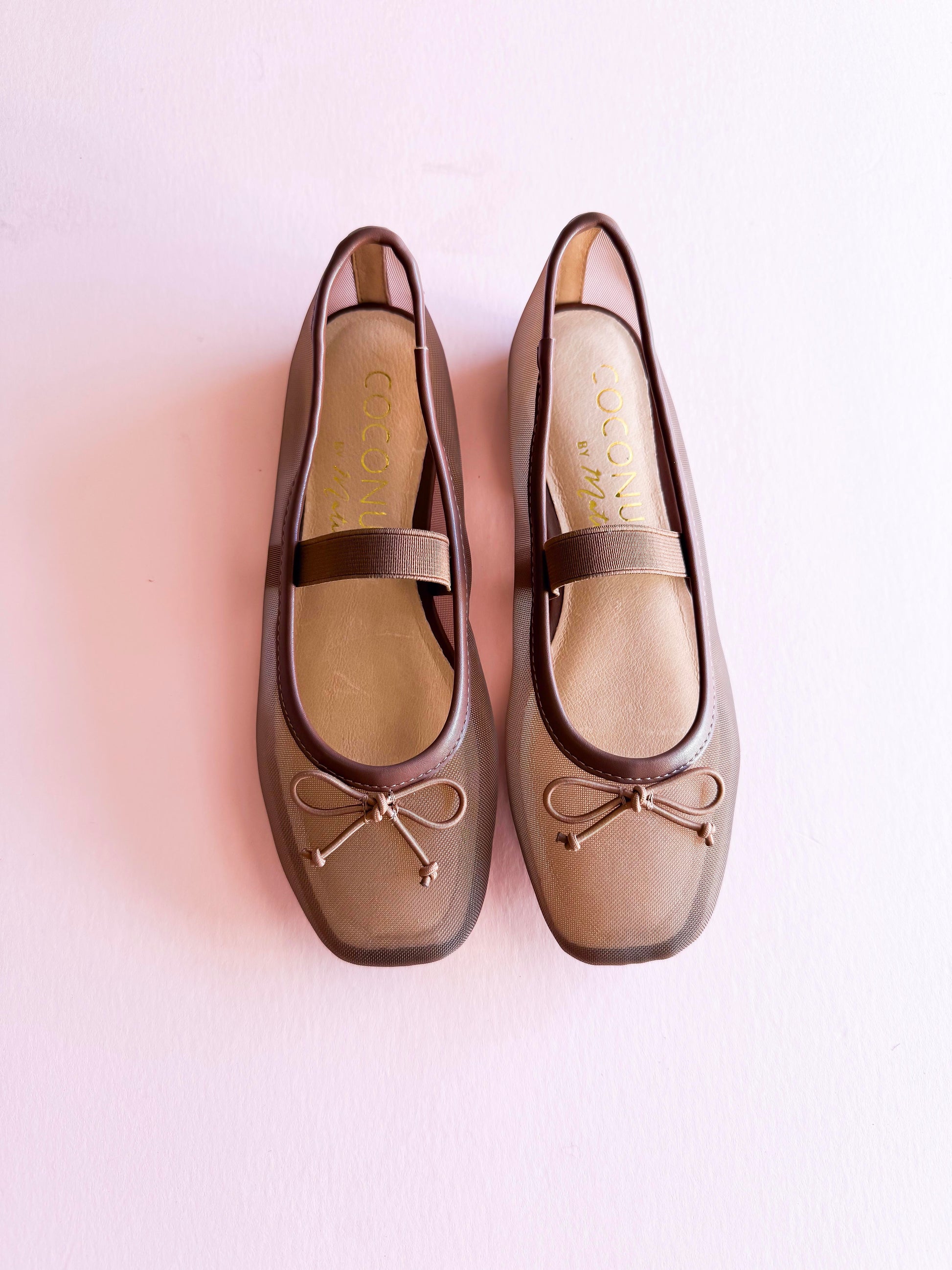Coconuts by Matisse Bronx mesh ballet flats in taupe with square toe, bow detail, and elastic strap on soft pink background