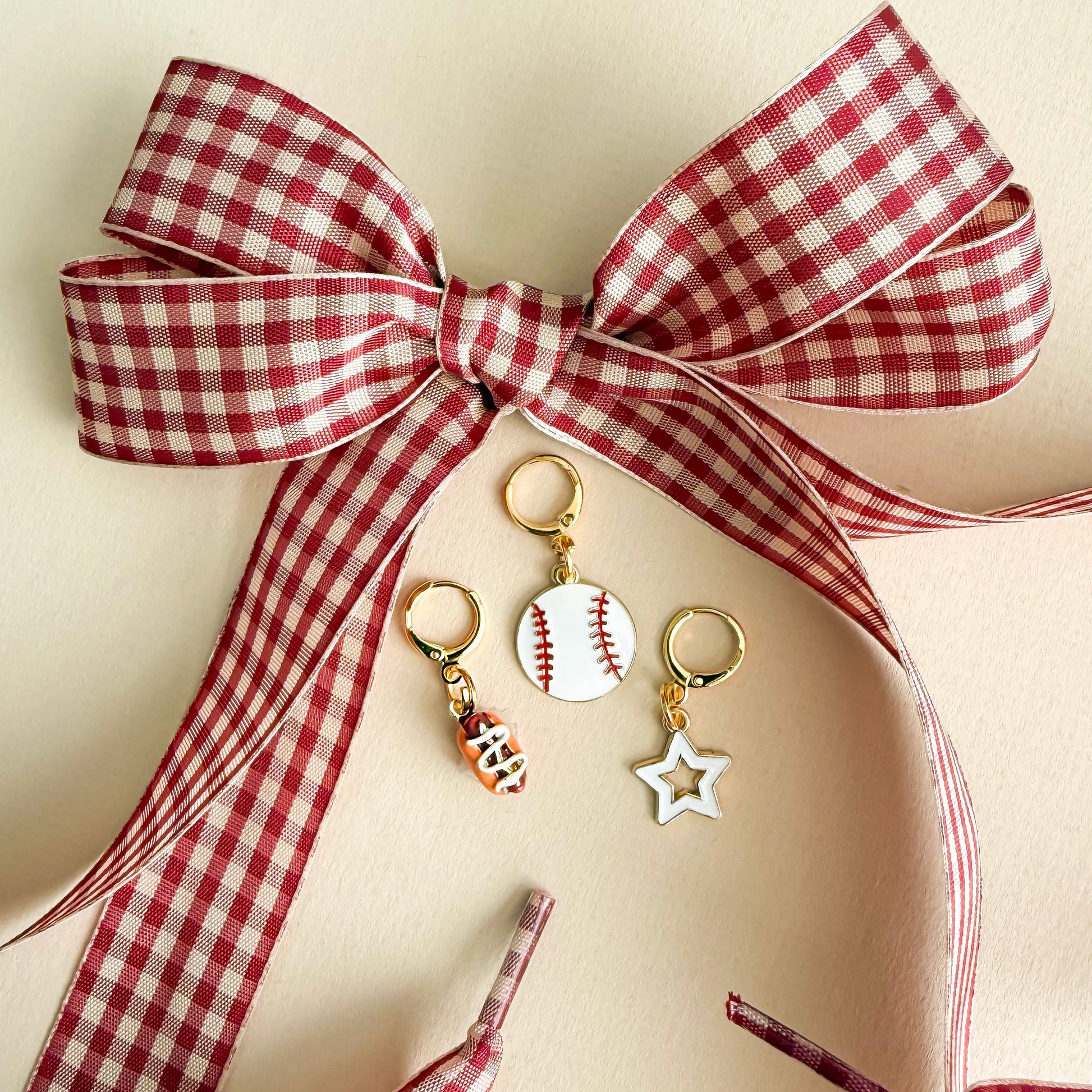 Baseball, hot dog and star charms hanging on sneaker laces