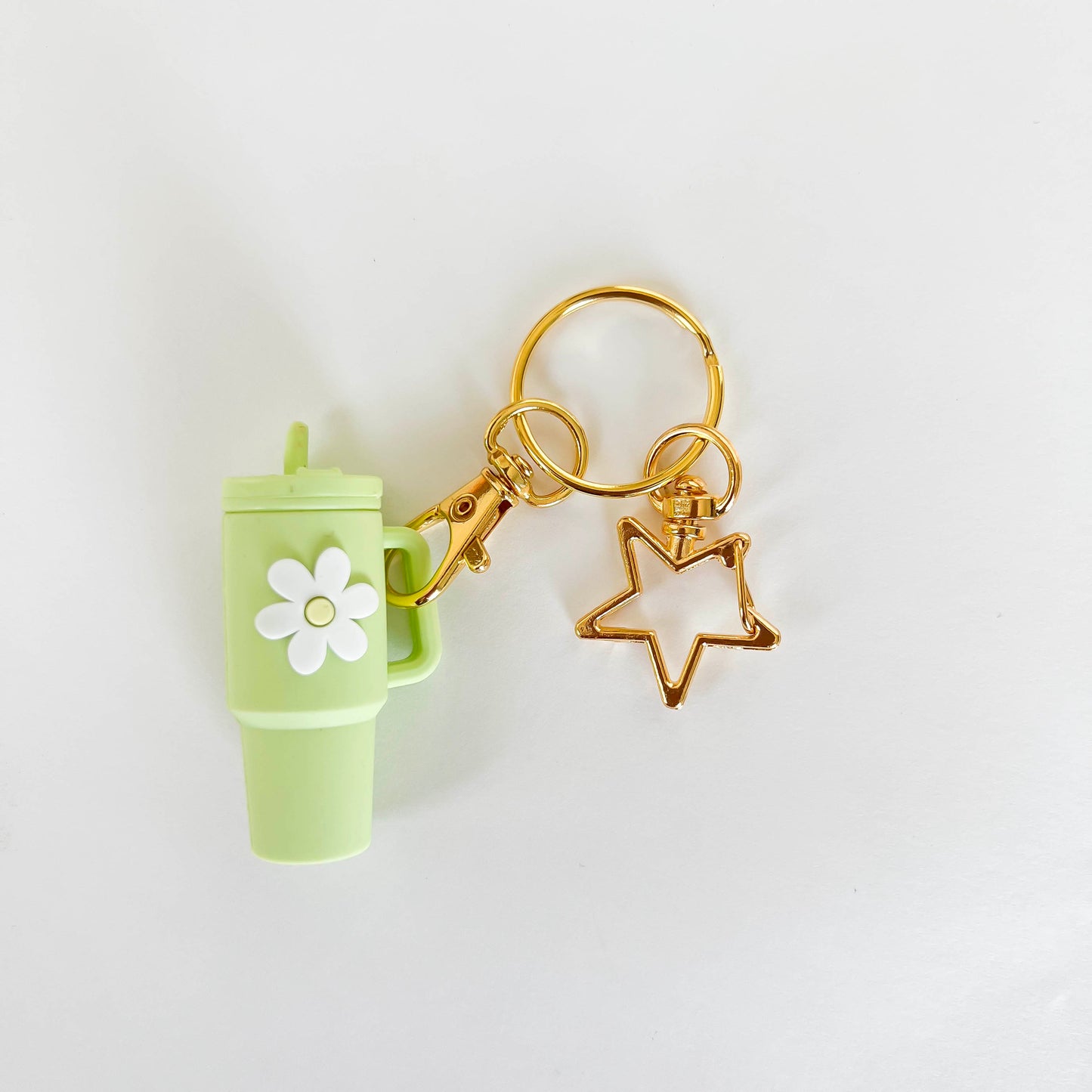 Mint green mini Stanley cup keychain with flower charm and gold star keyring