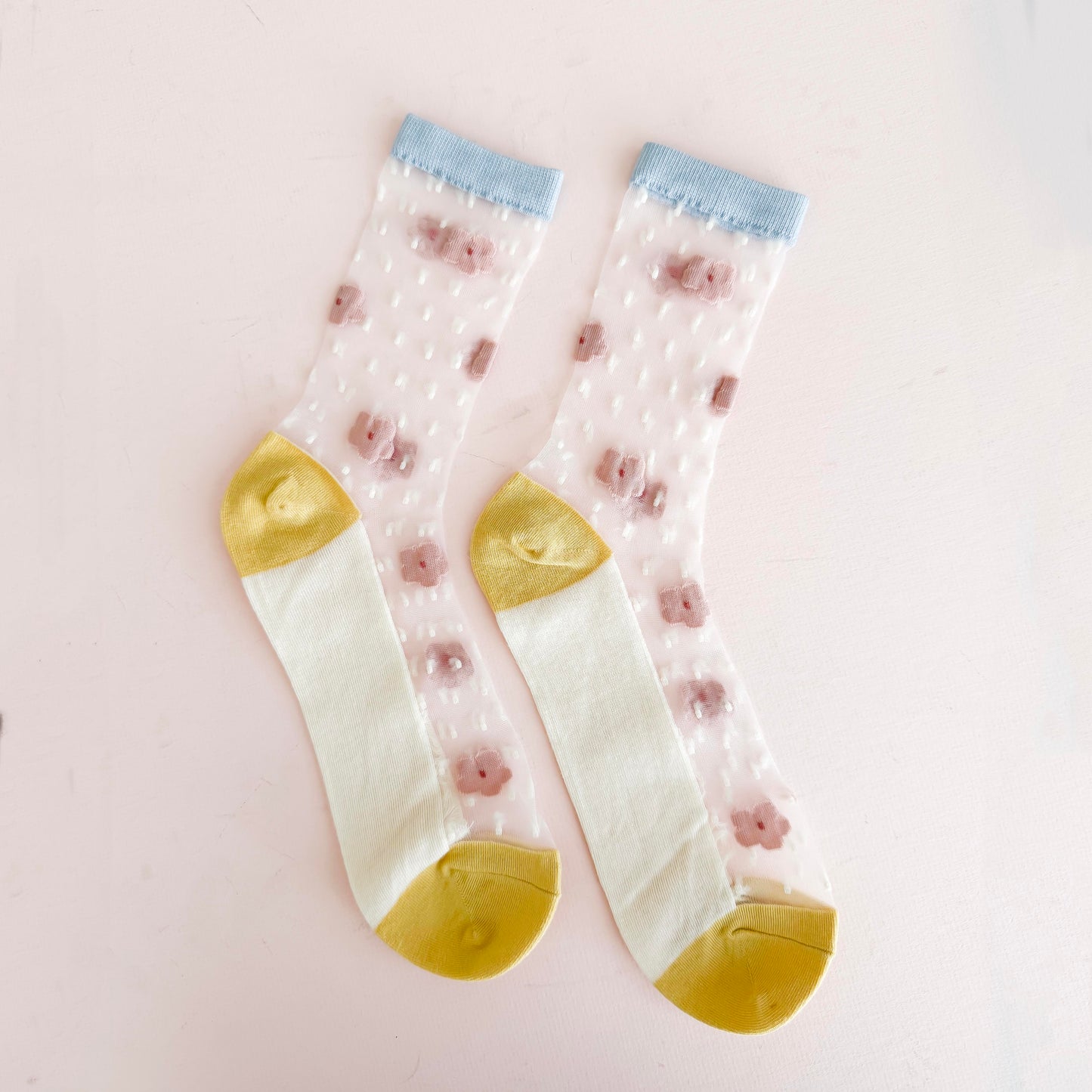 Dainty floral accents on transparent fabric for a playful, modern look