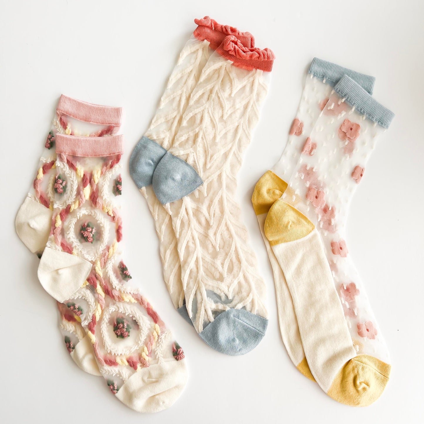 Transparent lace socks with a delicate blue bow and coral ruffled trim, stylish and breathable