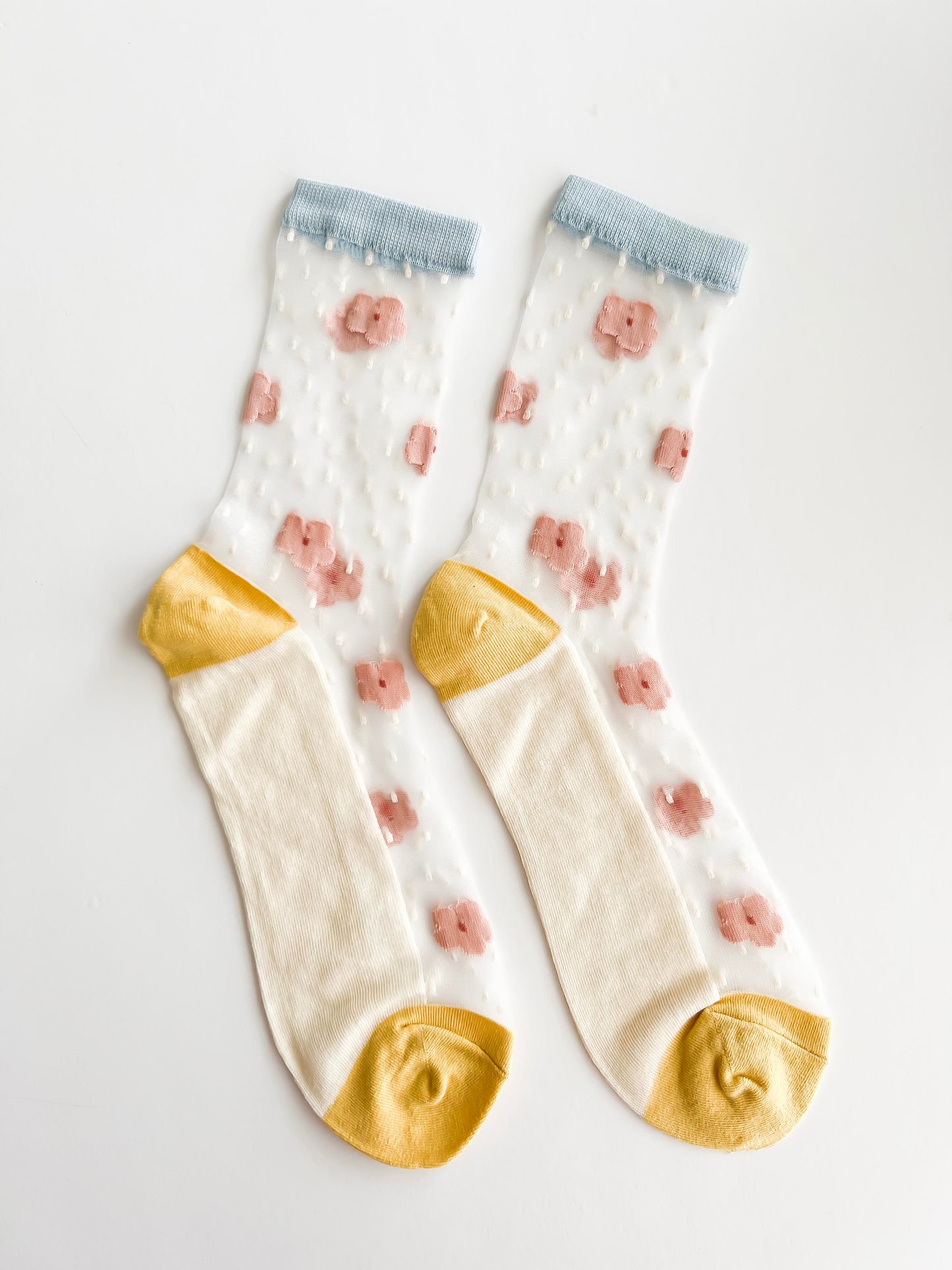 Transparent lace socks with a delicate blue bow and coral ruffled trim, stylish and breathable
