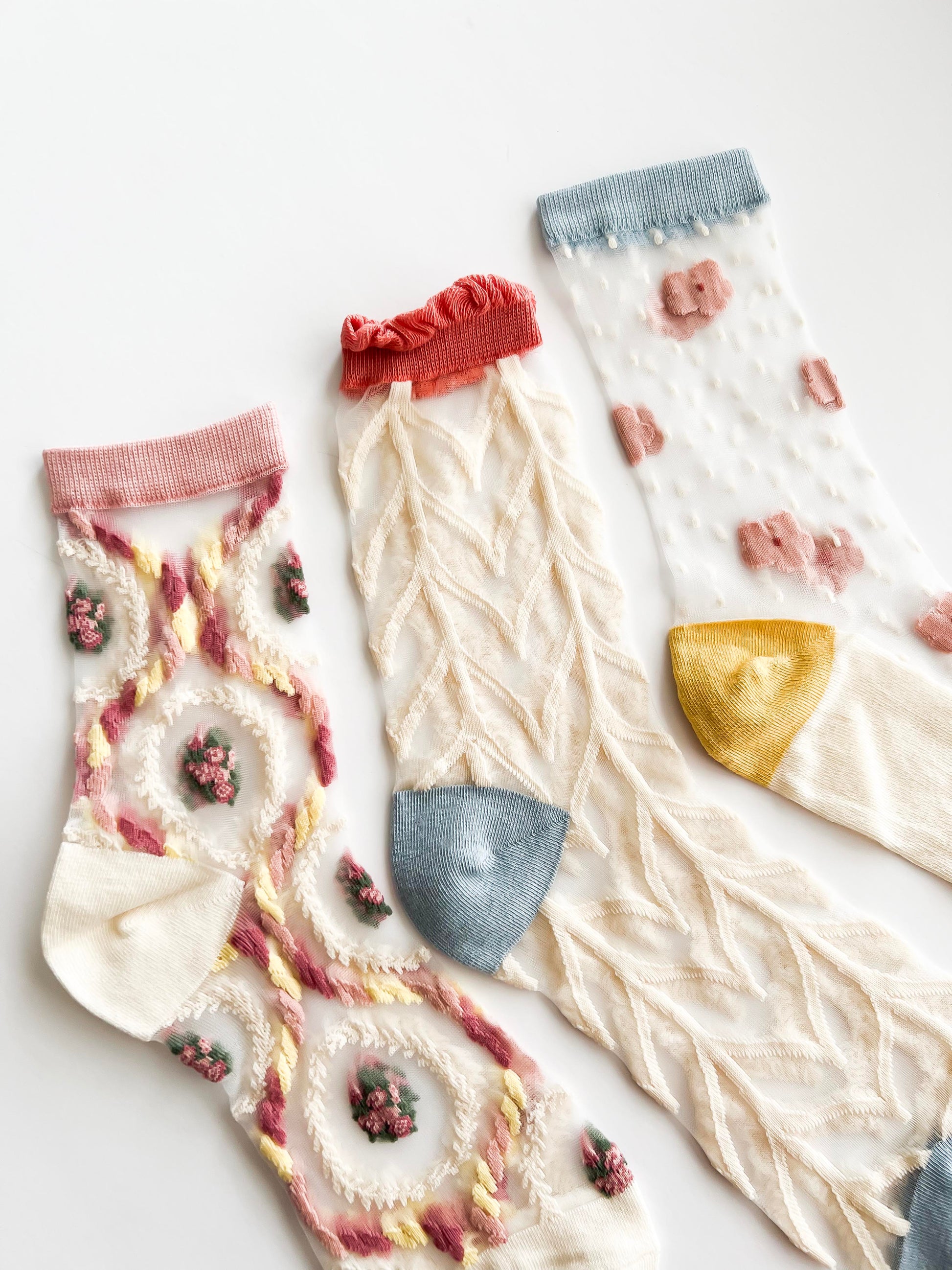 Transparent lace socks with a delicate blue bow and coral ruffled trim, stylish and breathable
