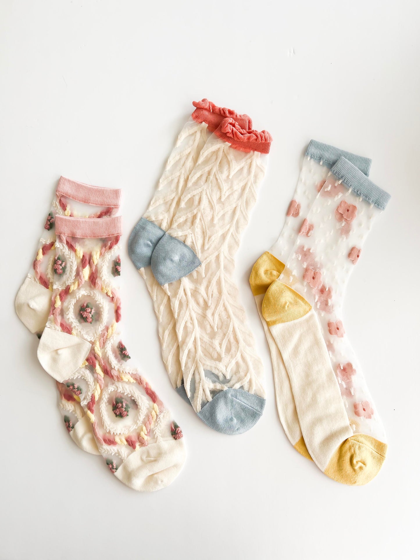 Transparent lace socks with a delicate blue bow and coral ruffled trim, stylish and breathable