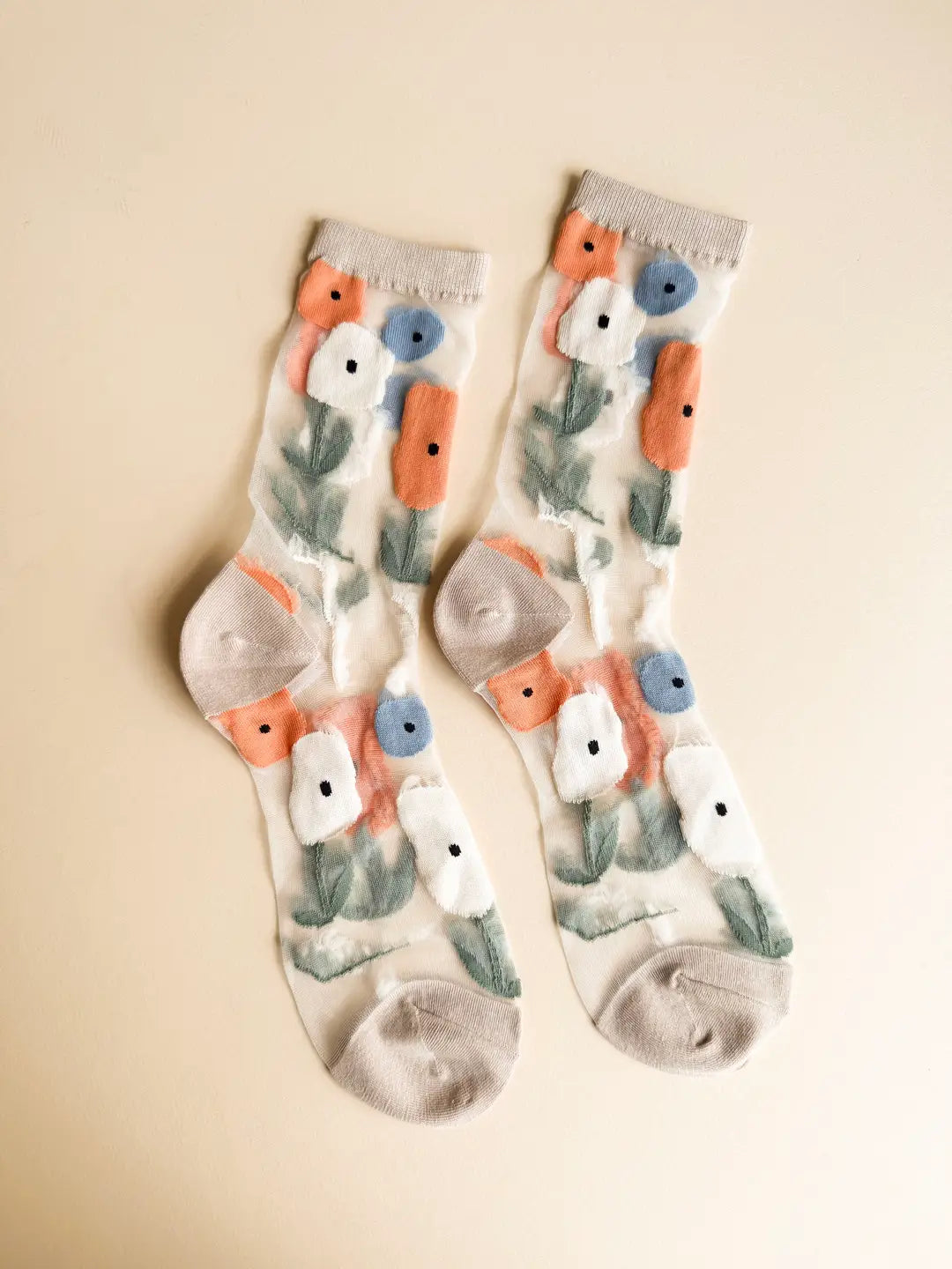 Pair of socks with floral pattern on a beige background
