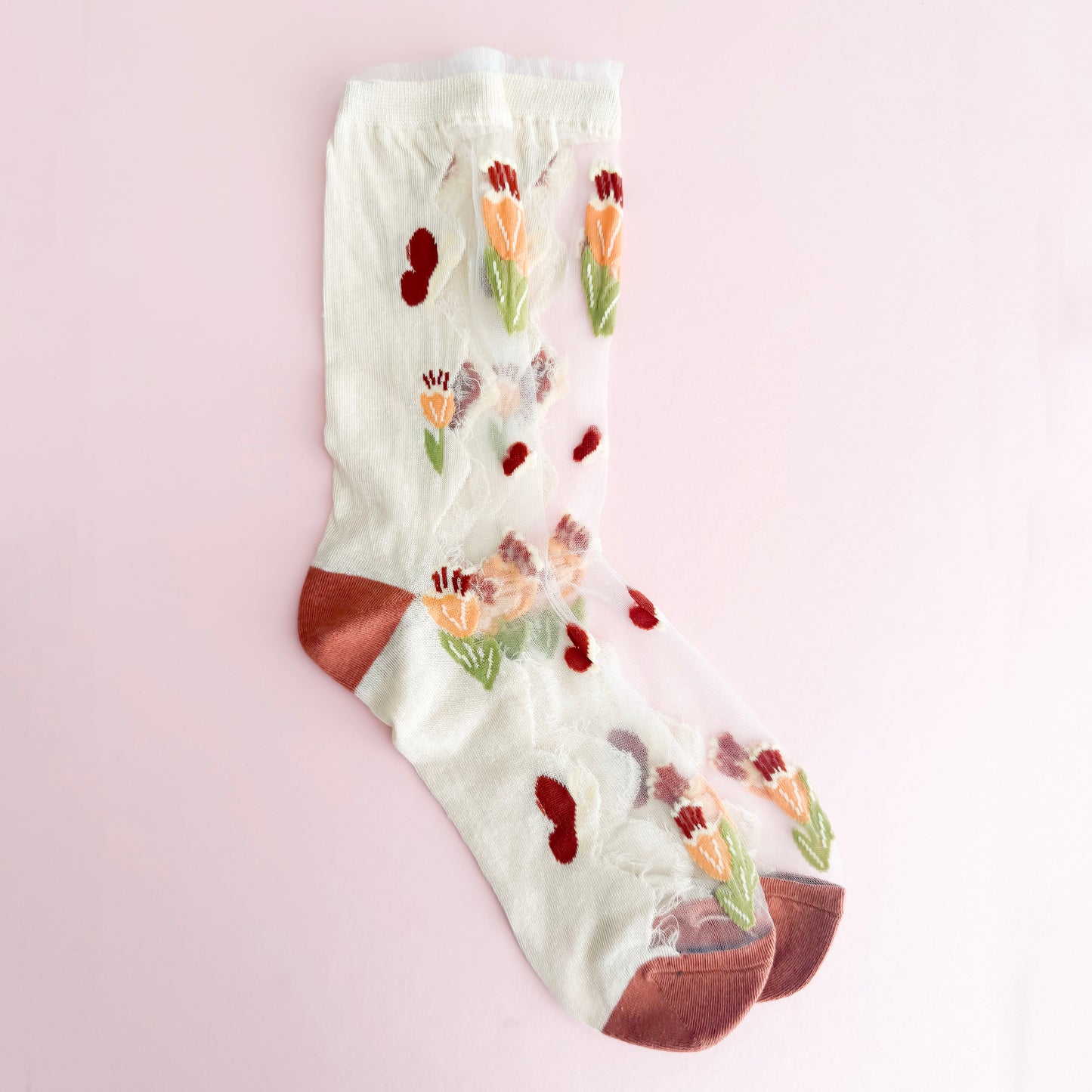 Floral-patterned sock on a light pink background