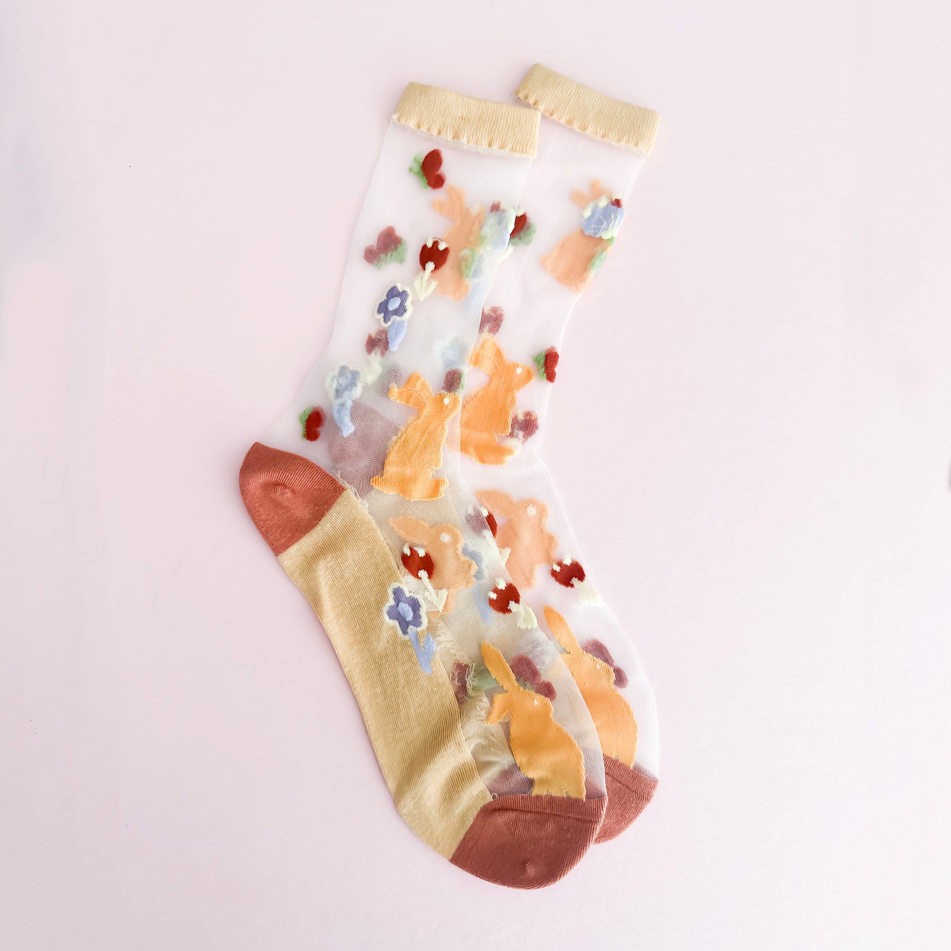 Colorful sock with cartoon character design on a light background