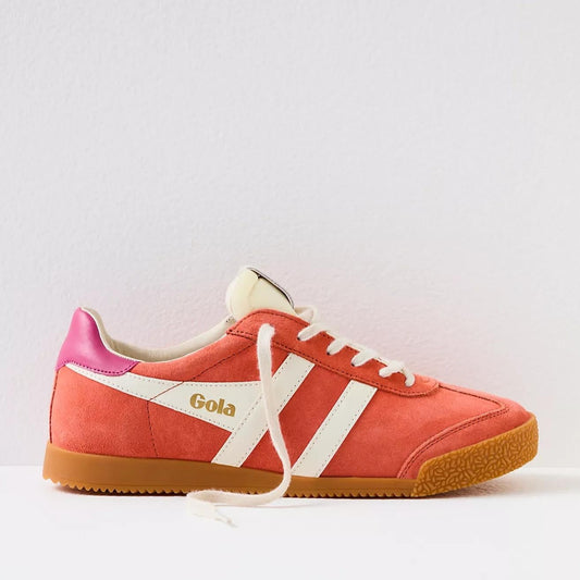 Gola sneakers in a vibrant color scheme of hot coral, off-white, and fuchsia. The shoes have a classic retro design with suede material and a gum rubber sole. The brand name "Gola" is prominently displayed on the side and tongue of the sneakers in gold lettering. The laces and stripes are off-white, providing a striking contrast to the bold coral and fuchsia colors.