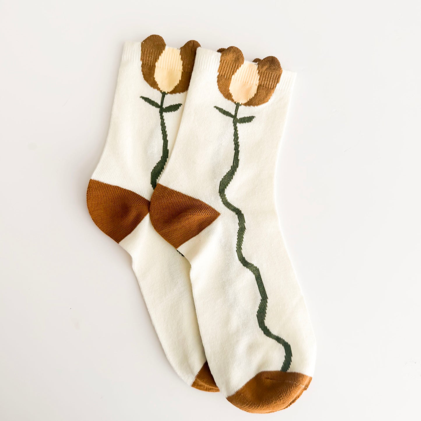 Pair of socks with floral design on a light gray background
