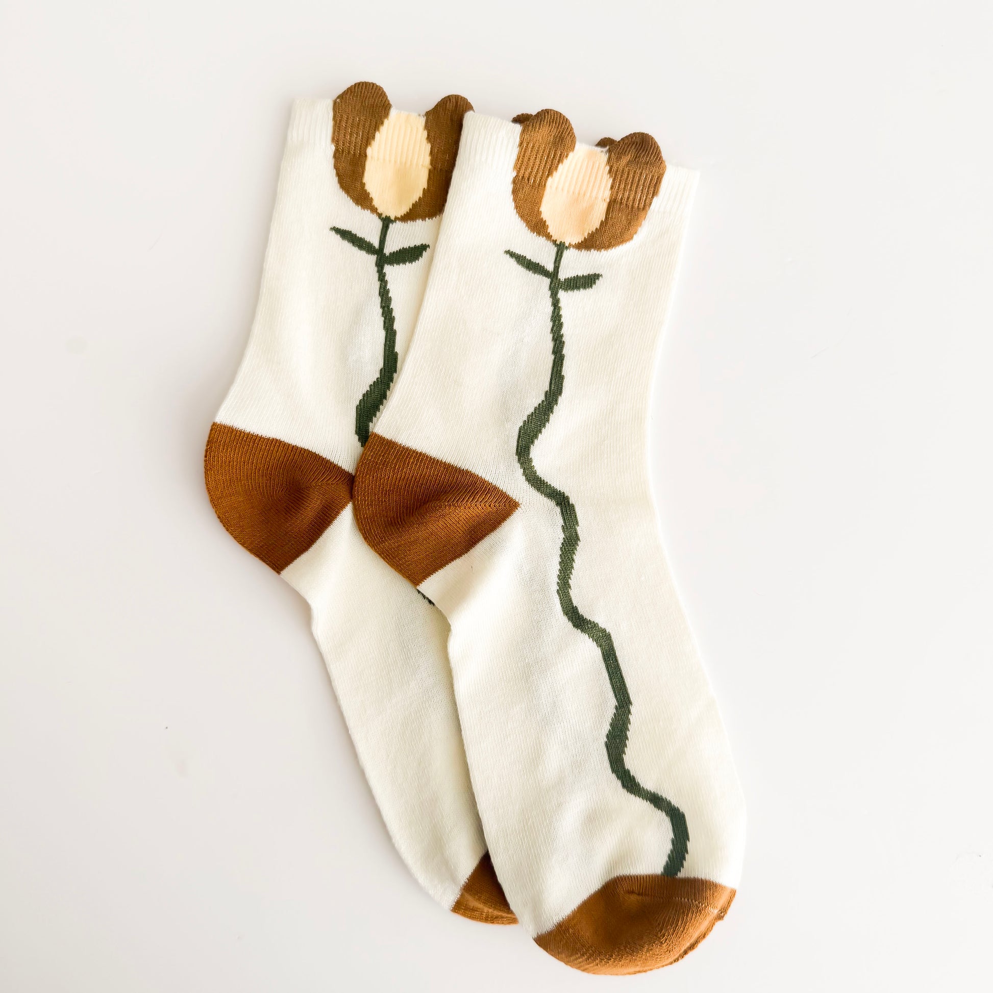 Pair of socks with floral design on a light gray background